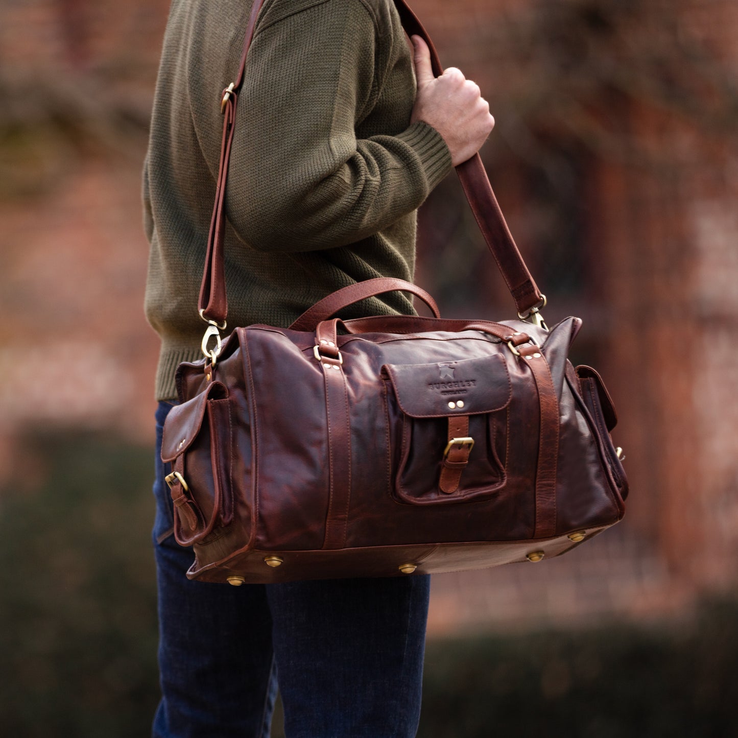 Brown full leather rugged holdall in classic English country style. Handmade from full grain vegetable tanned cow leather.