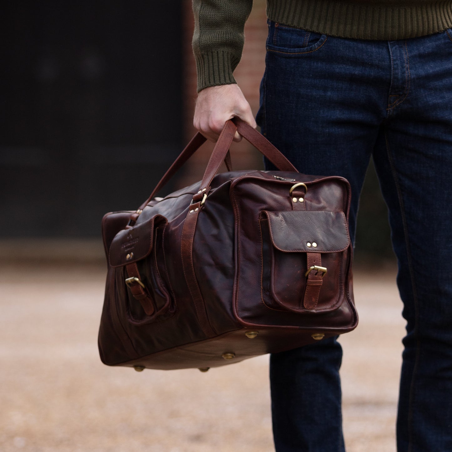 Brown full leather rugged holdall in classic English country style. Handmade from full grain vegetable tanned cow leather.