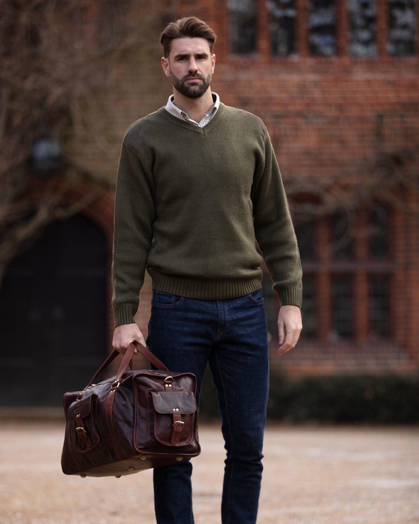 Brown full leather rugged holdall in classic English country style. Handmade from full grain vegetable tanned cow leather.