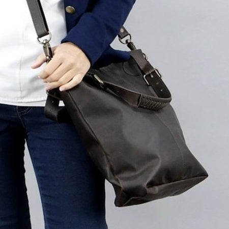 Dark brown, full leather handbag in classic English country style with adjustable shoulder straps and handles. Handmade from full grain vegetable tanned cow leather.