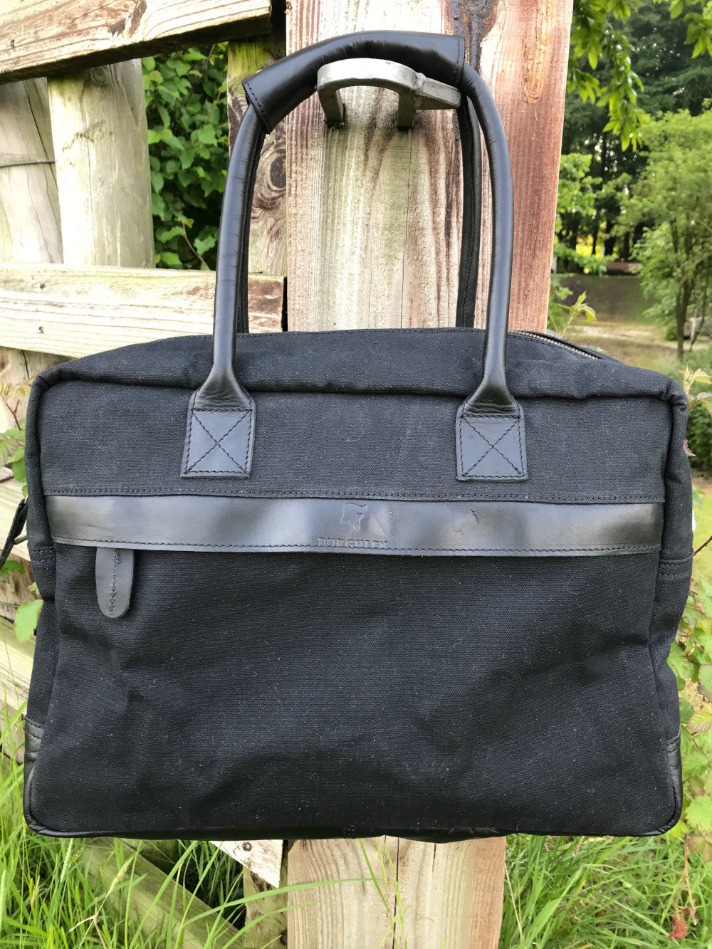 The Breton Briefcase. A casual work bag by Burghley Bags. Handmade from strong cotton canvas and supple leather.  Shown in elegant black.