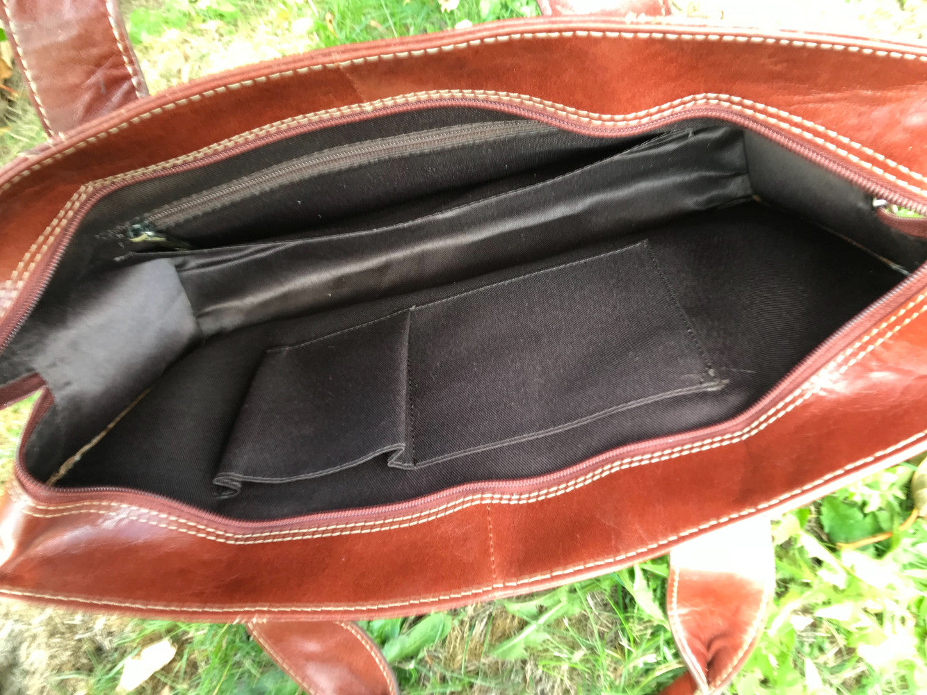 The Easton Briefcase. An elegant and modern work bag by Burghley Bags. Handmade from luxurious chestnut leather, it's large enough for 15" laptops. Comes with a detachable shoulder strap.