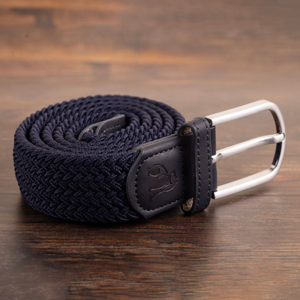 Navy braided belt with a silver buckle on a wooden surface