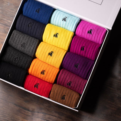 Box of colorful socks with a brand logo on a wooden surface