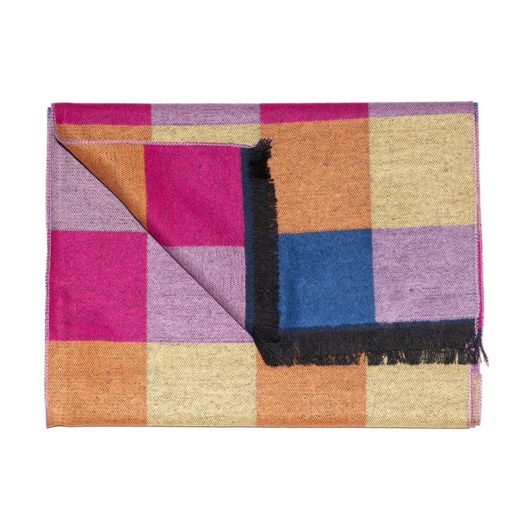 Colorful checkered blanket with a black fringe on a white background