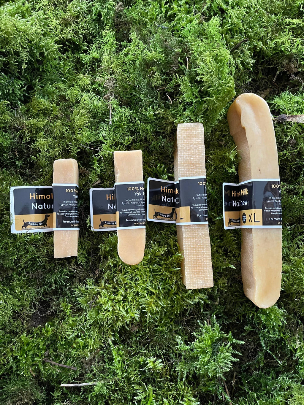 Set of Himalayan salt sticks with packaging on a green moss background
