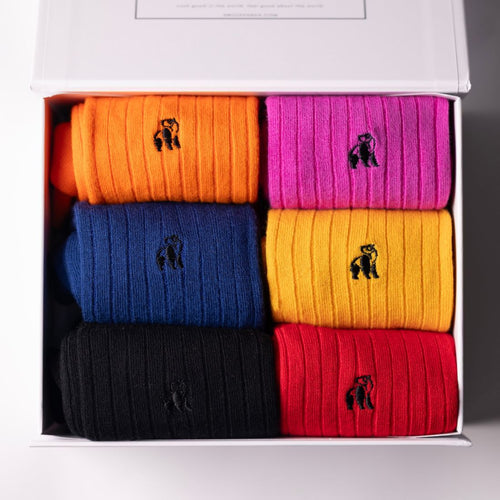 Set of colorful socks with a brand logo in a box
