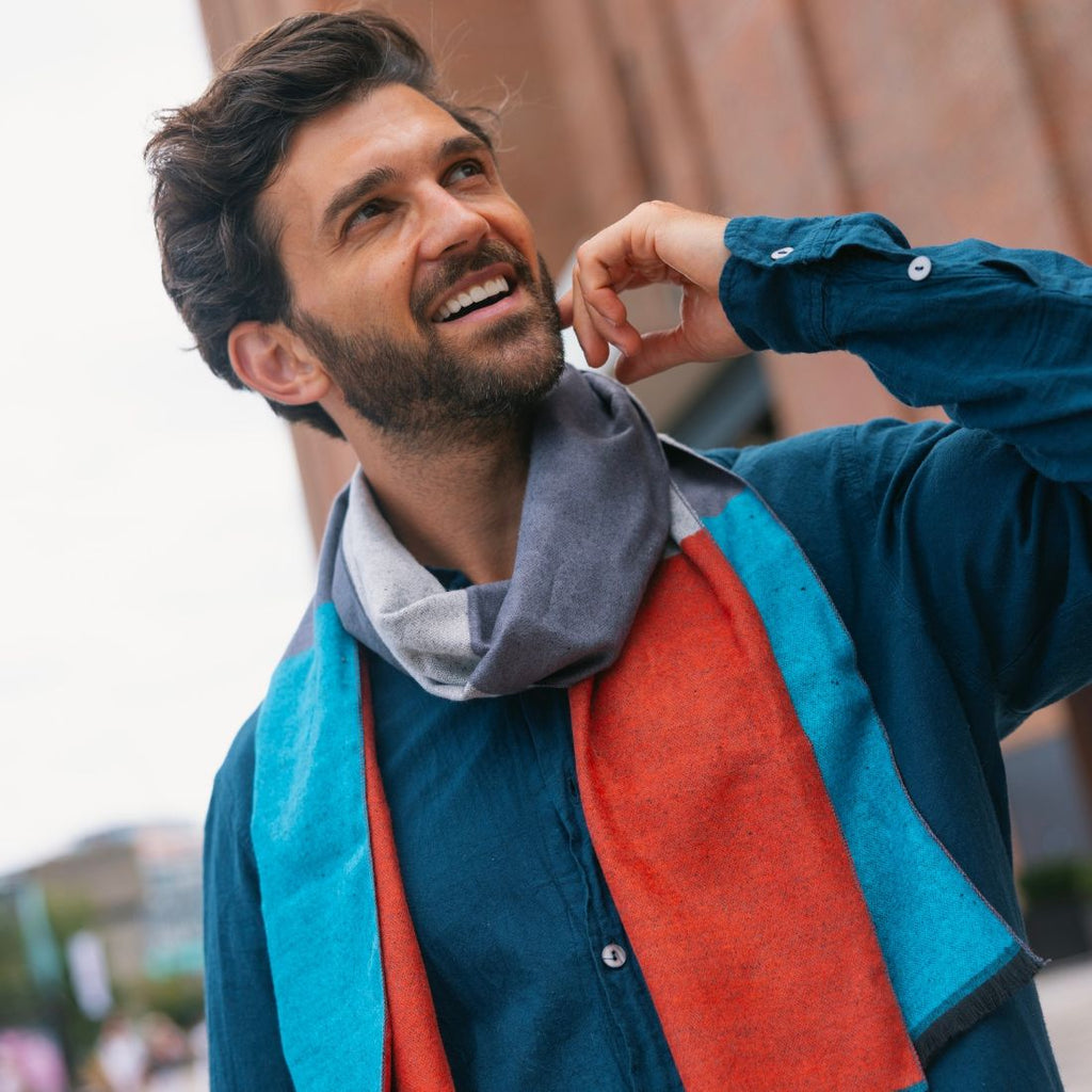 Man wearing a colorful jacket with a blurred background