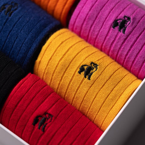 Colorful headbands in a box with a brand logo.