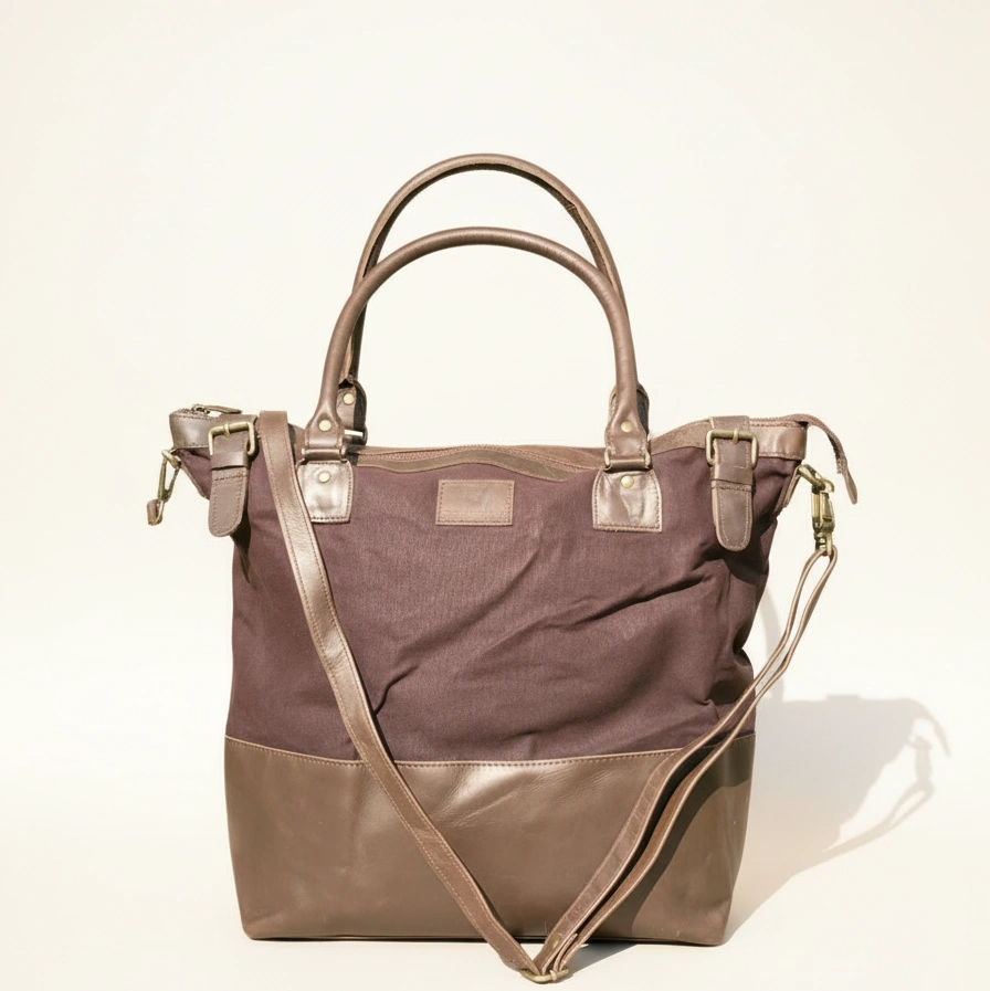 Two-tone handbag with brown top section and beige bottom section on a light background