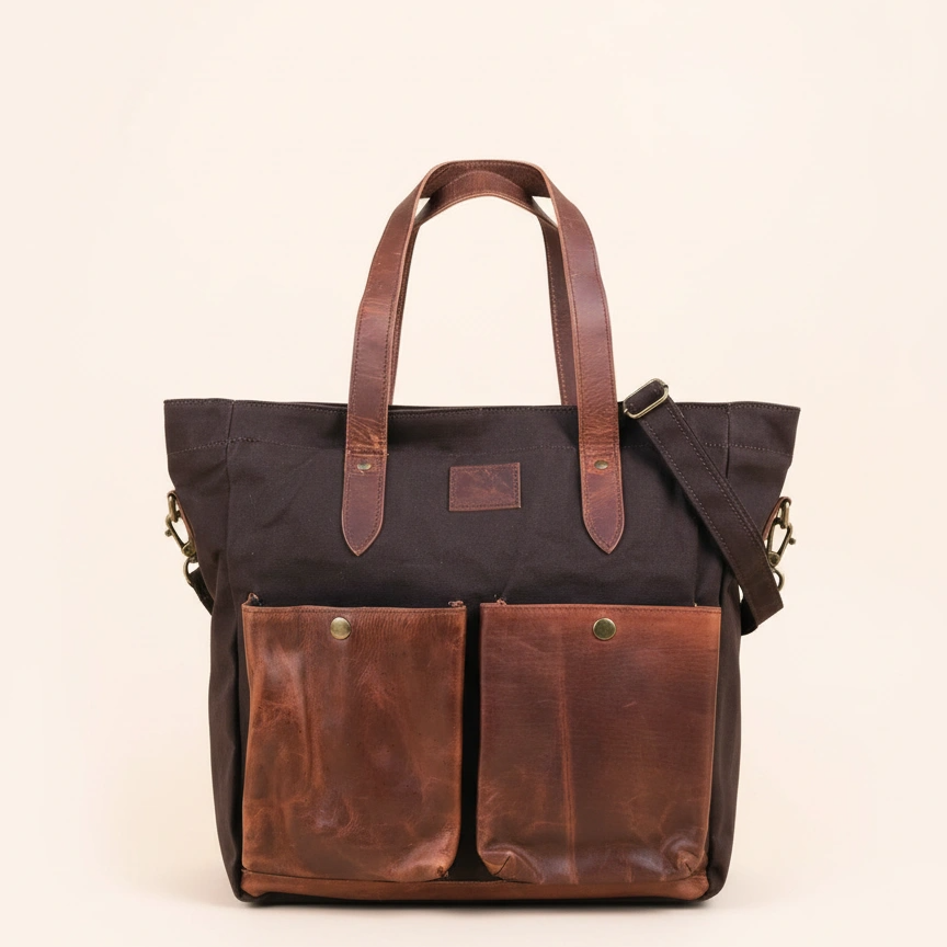 Black and brown leather tote bag on a beige background