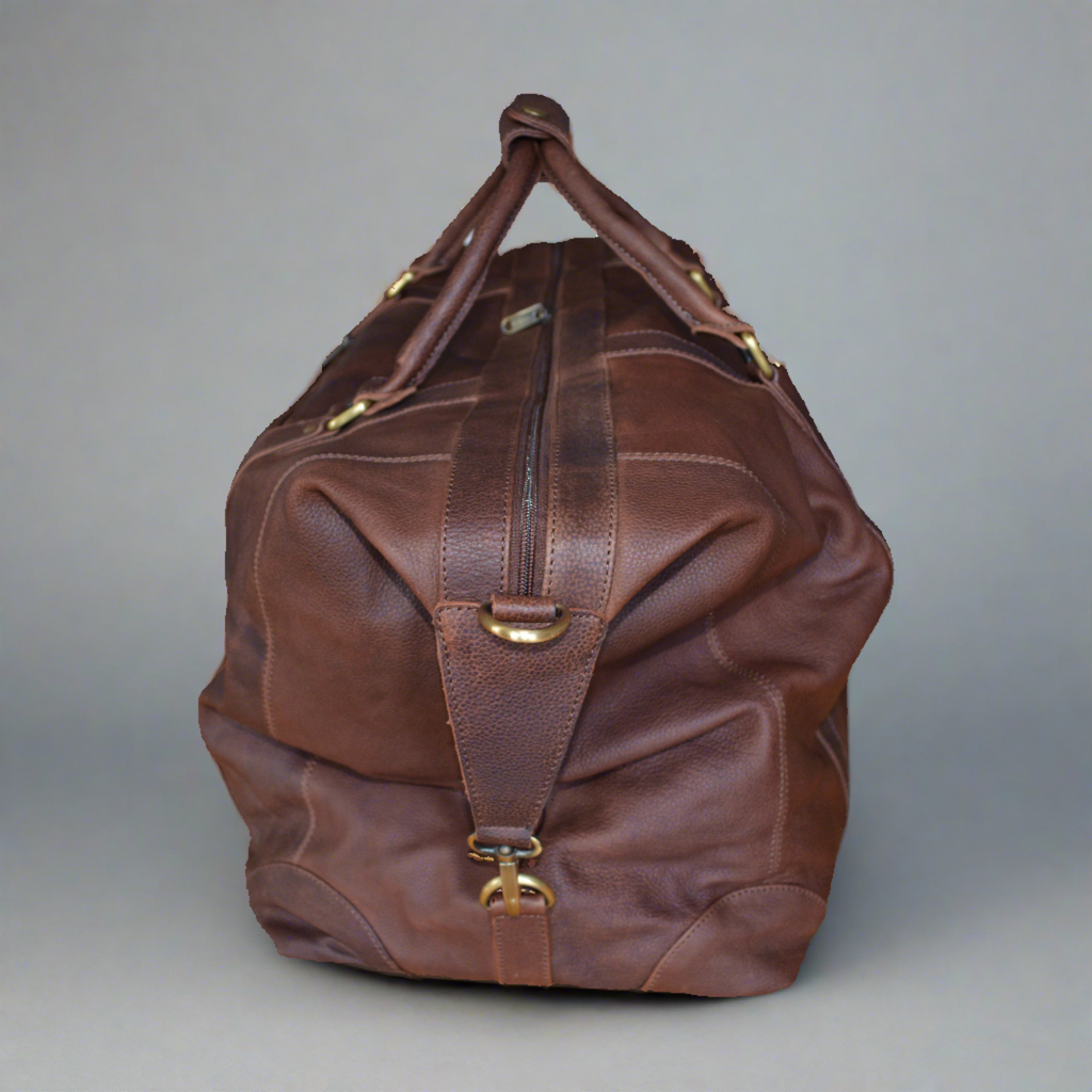 Full leather holdall travel bag in full grain vegetable tanned cow leather. Side view.