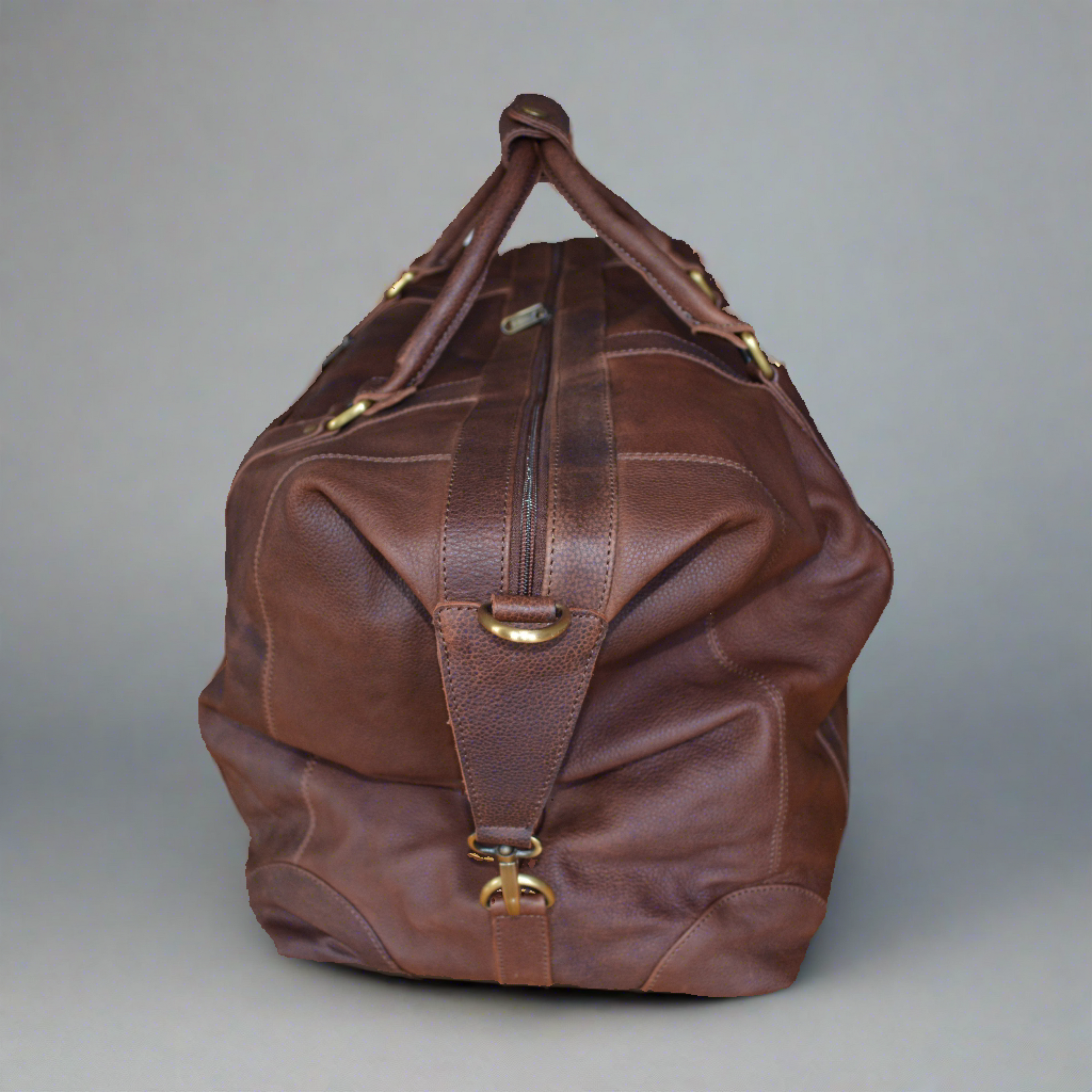 Full leather holdall travel bag in full grain vegetable tanned cow leather. Side view.