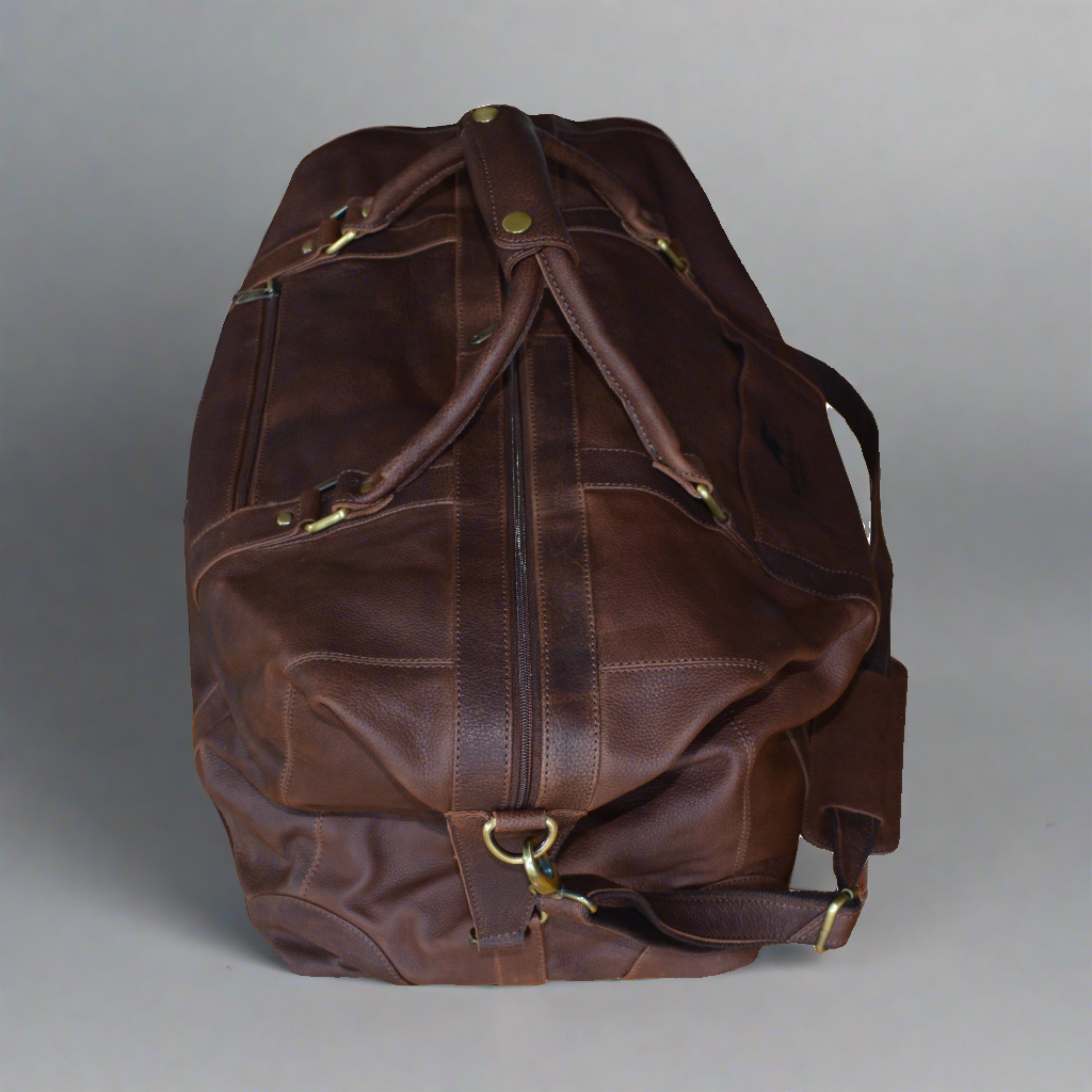 Full leather holdall travel bag in full grain vegetable tanned cow leather. Side view.