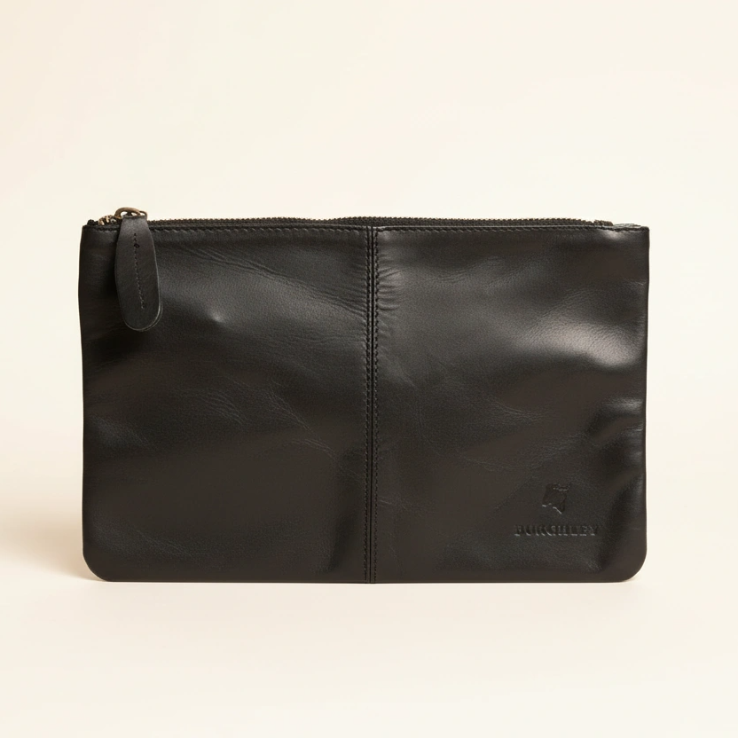 Black leather pouch on a beige background