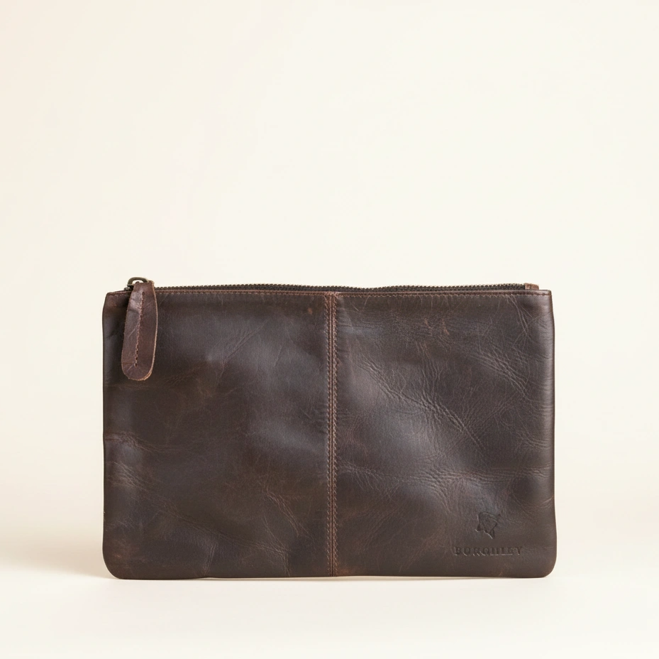 Brown leather pouch on a beige background