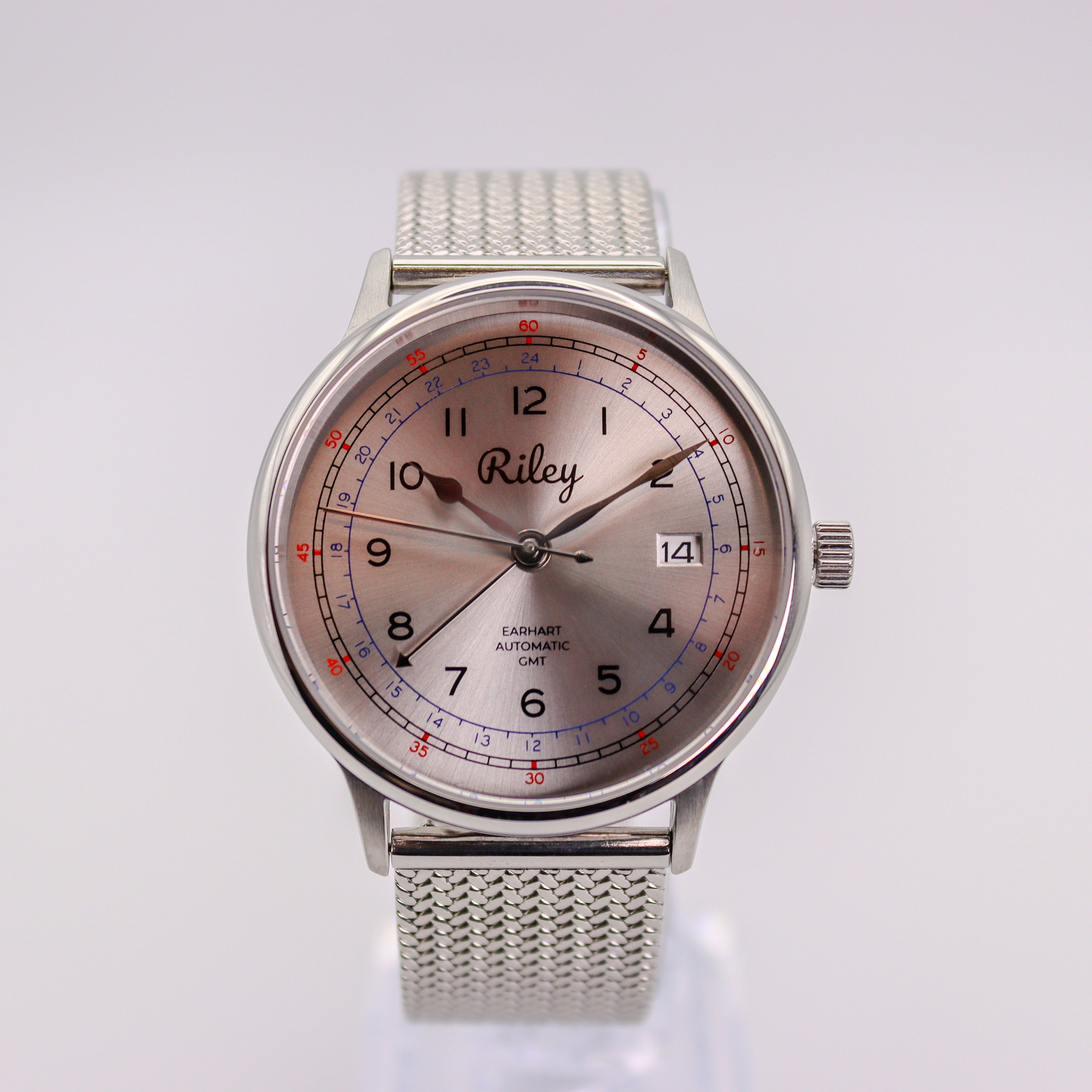 Silver watch with a detailed face on a white background