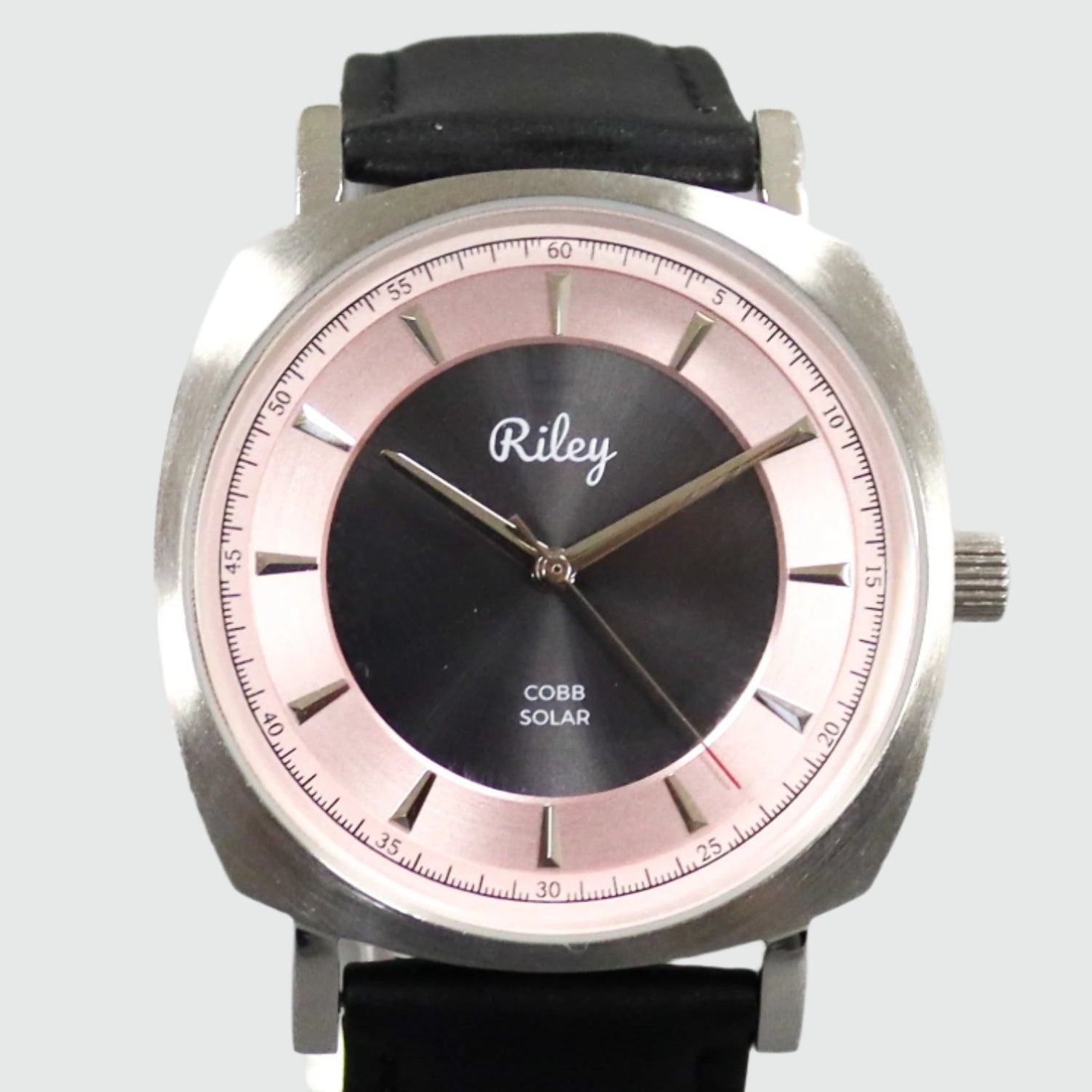 Wristwatch with black strap and silver case on a light gray background