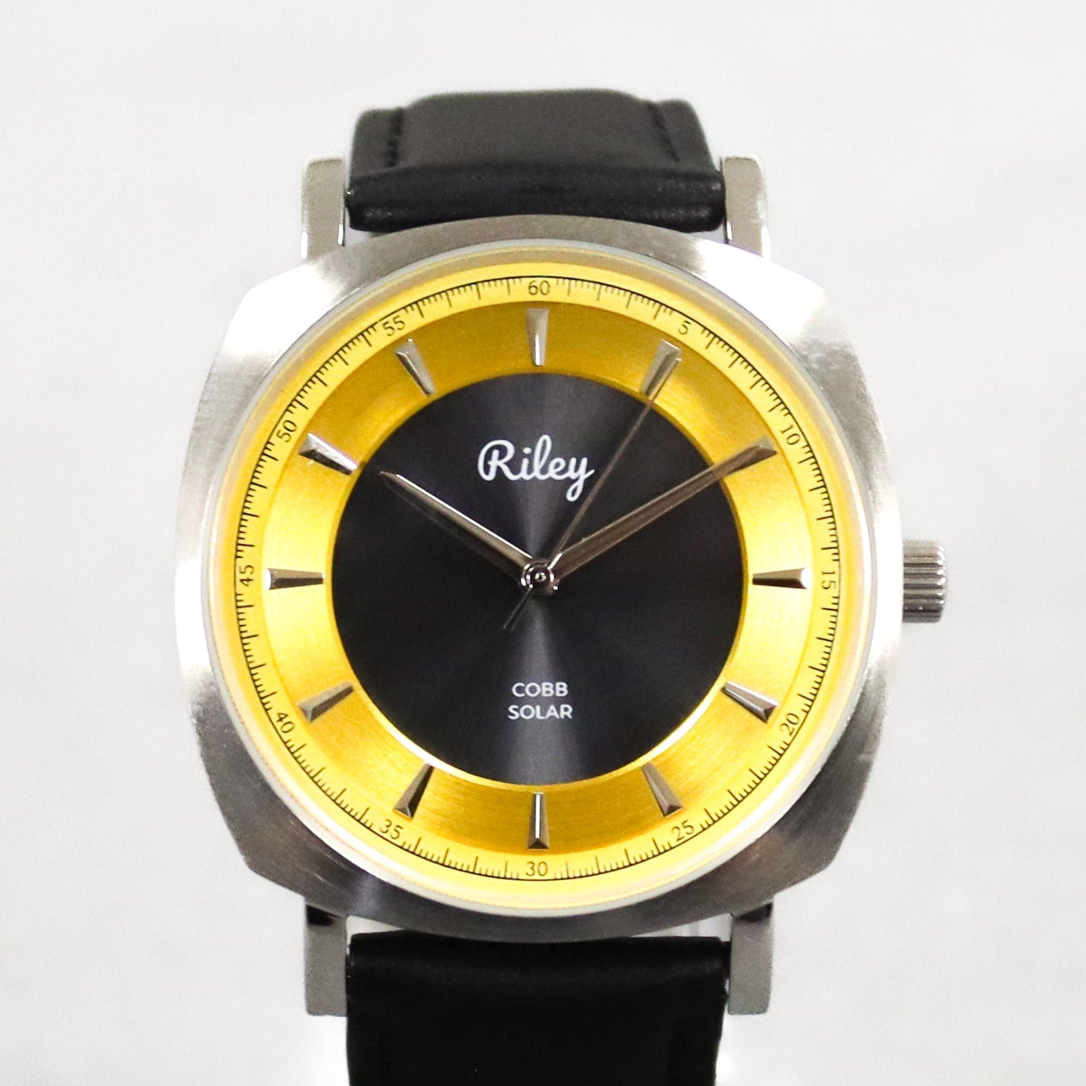Wristwatch with black strap and yellow face on a white background