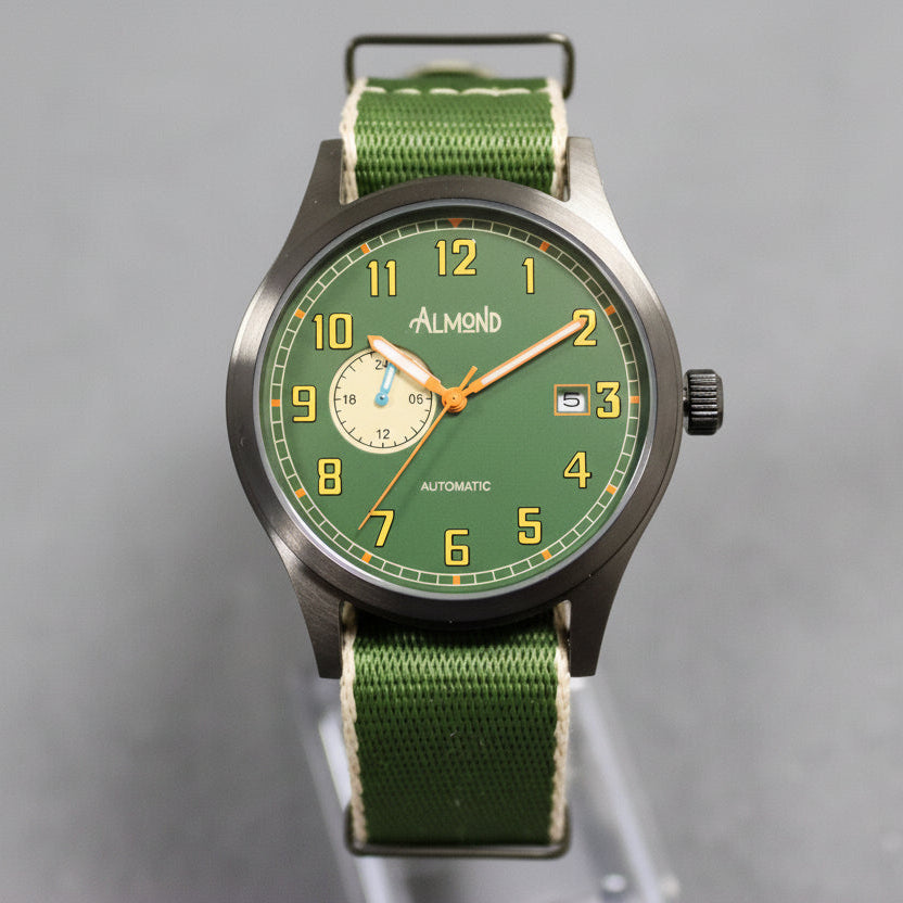 Green watch with a detailed face on a gray background