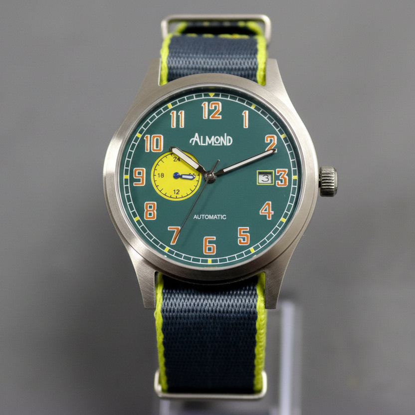 Watch with a green face and blue strap on a gray background