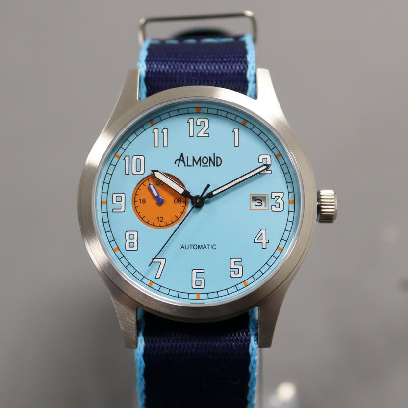 Watch with blue strap and orange face on a gray background