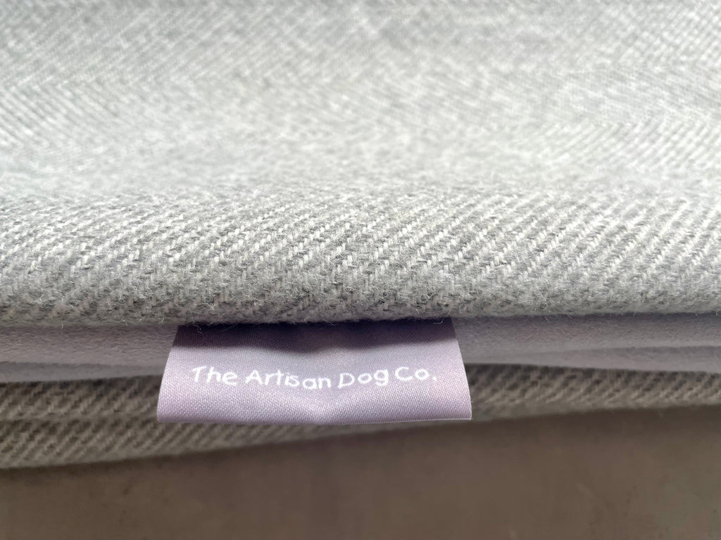 Stack of gray fabric with a label from The Artisan Dog Co.