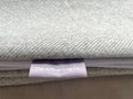 Stack of gray fabric with a label from The Artisan Dog Co.