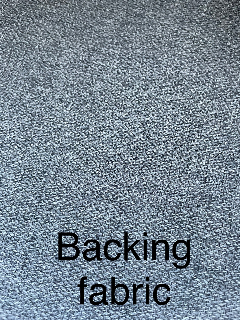 Close-up of gray textured fabric with 'Backing fabric' text overlay