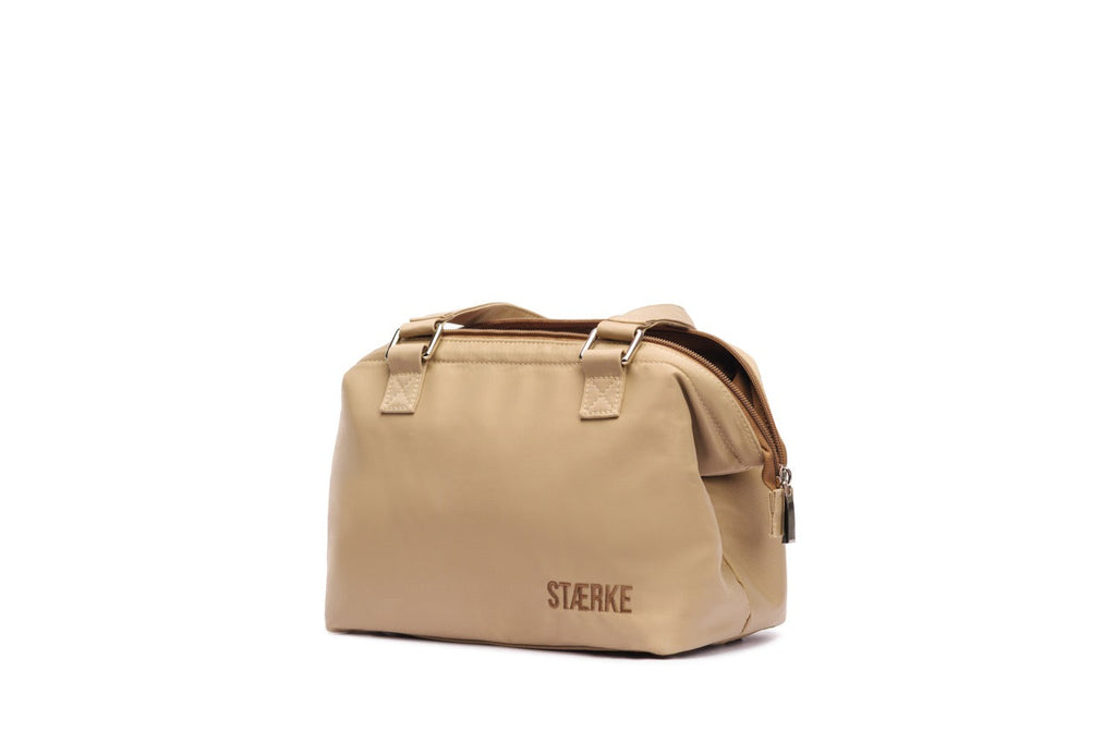Beige toiletry bag with 'Stärke' branding on a white background