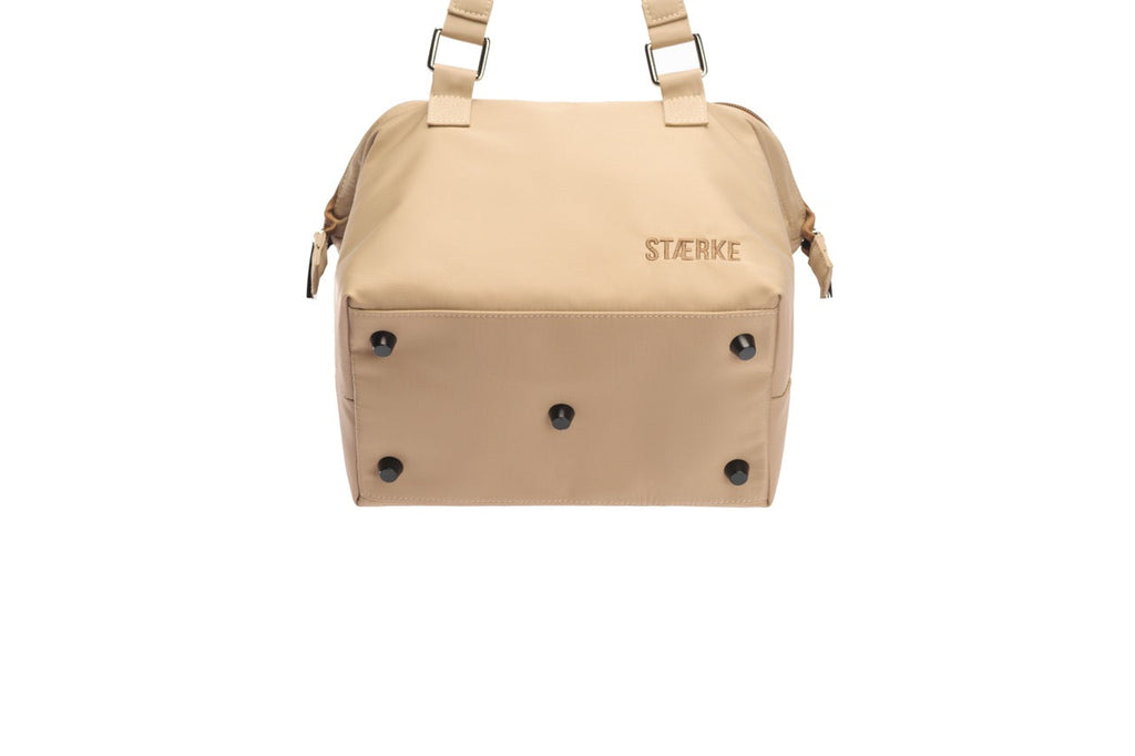Beige bag with 'Storke' branding on a white background
