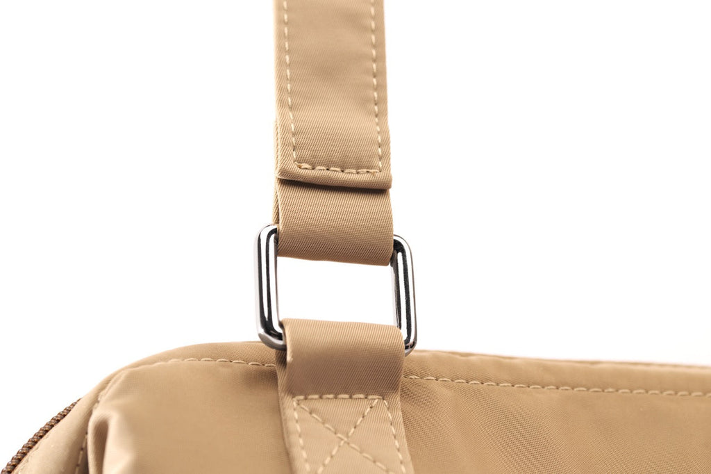 Close-up of a beige bag with a strap on a white background