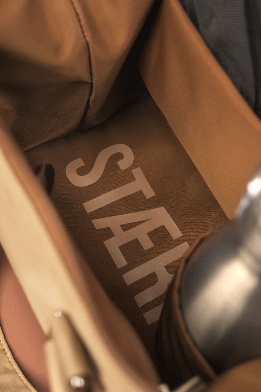 Brown leather seat with 'STARK' branding on a vehicle interior.