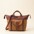 Brown and beige bag with a strap on a beige background