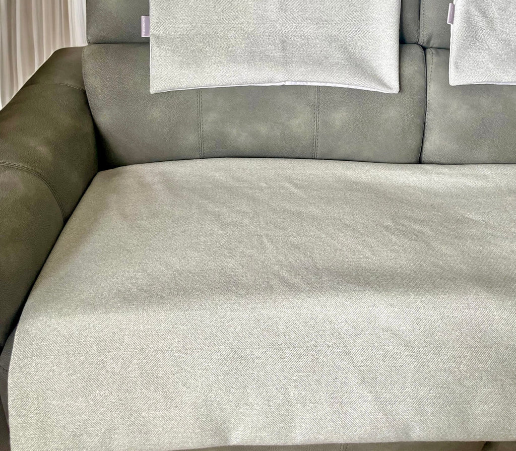 Gray sectional sofa with cushions in a room setting