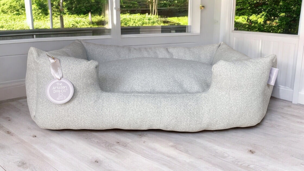 Large pet bed on a wooden floor with a window in the background