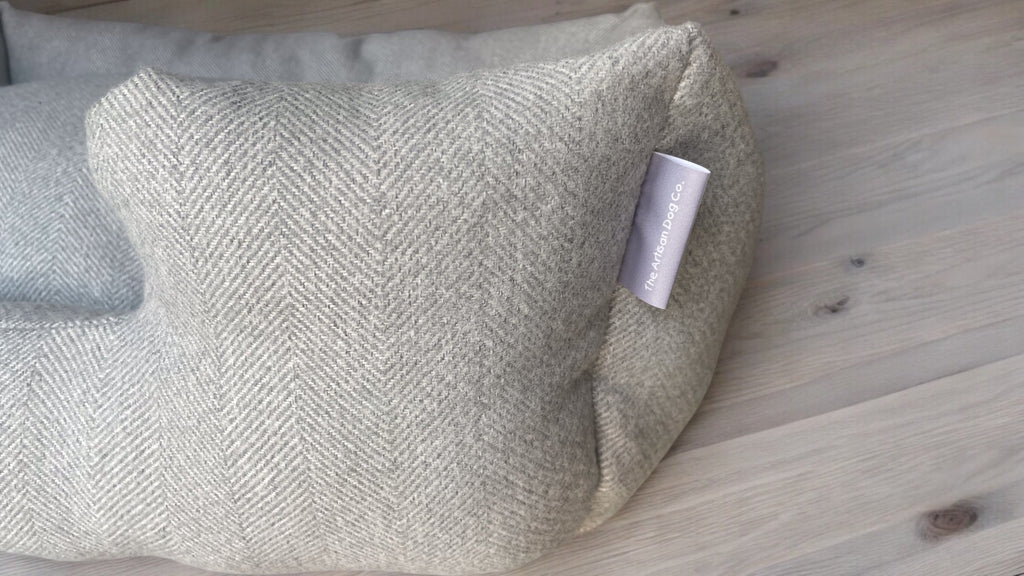 Textured pillow with a brand tag on a wooden surface