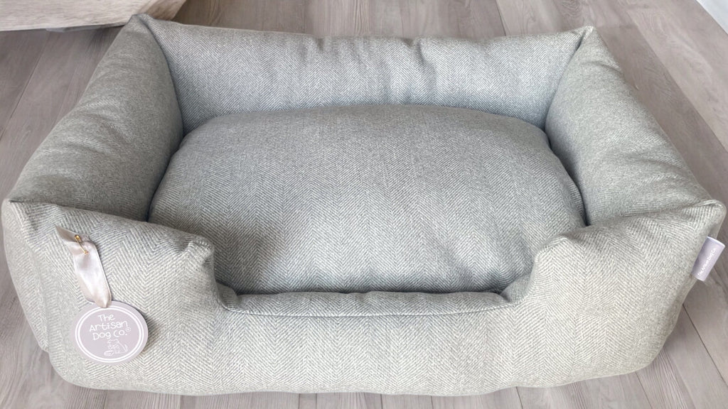 Gray pet bed on a wooden floor