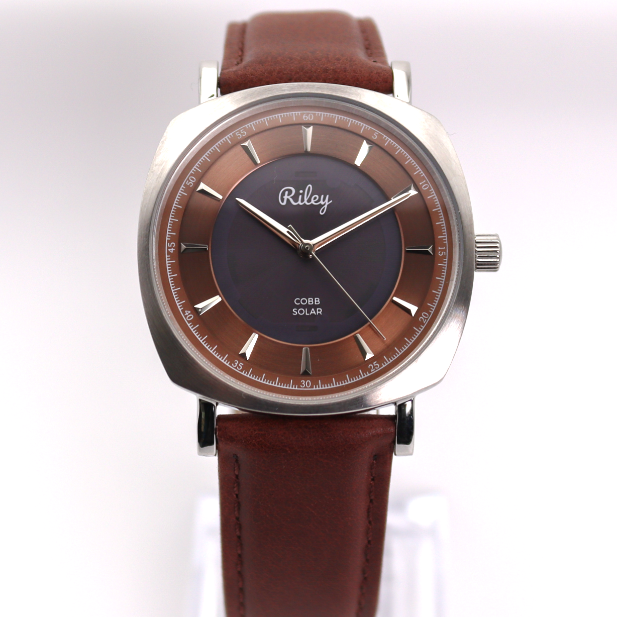 Wristwatch with brown leather strap and dark brown dial on a white background