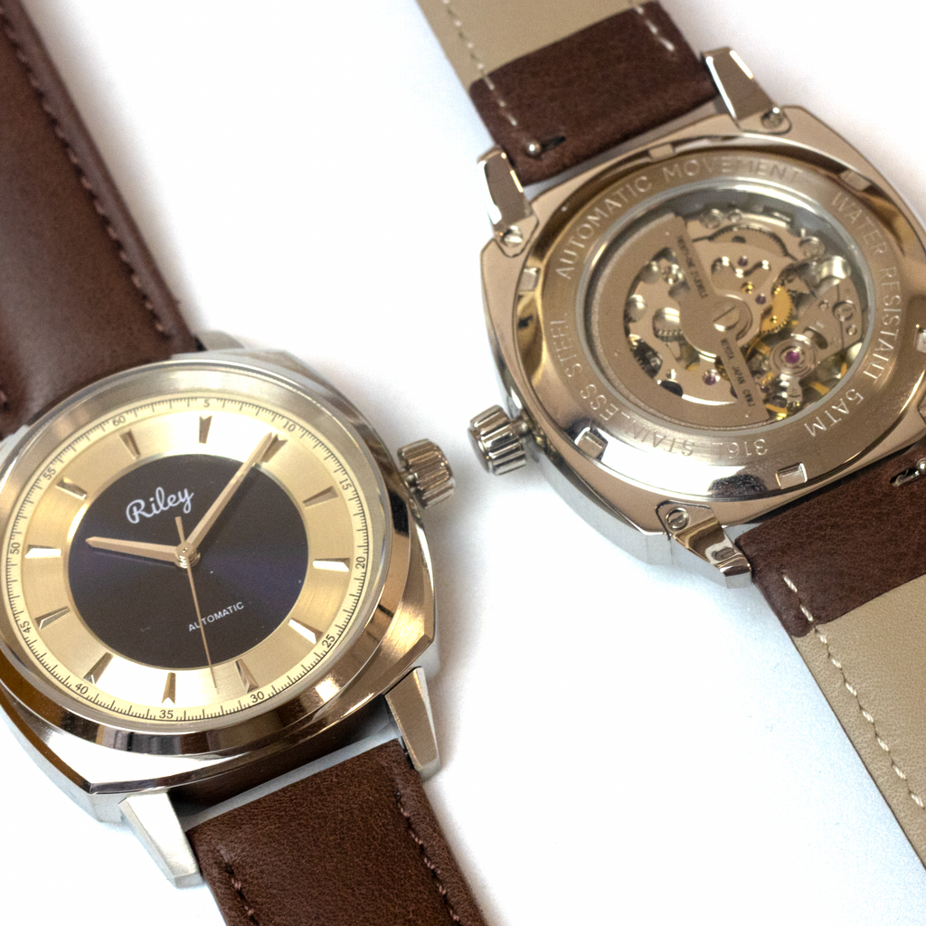 Two watches with brown leather straps and gold accents on a white background