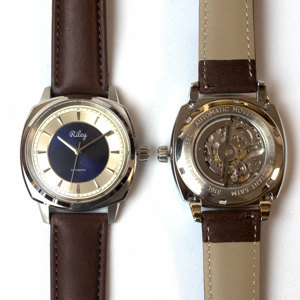 Two watches with brown leather straps on a white background