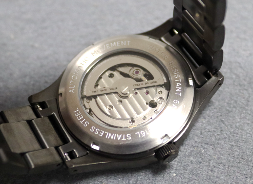 Close-up of a watch mechanism on a gray background