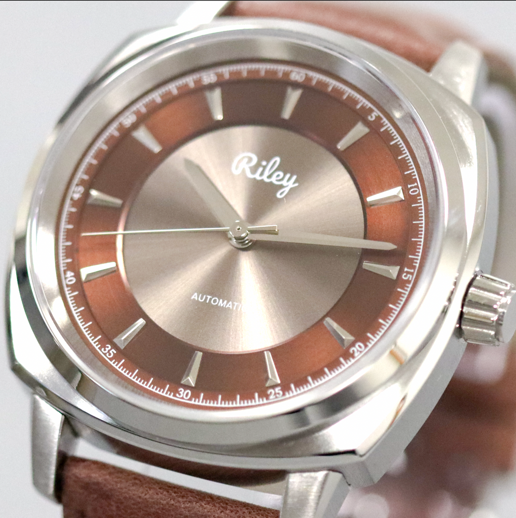 Watch with brown face and leather strap, featuring the brand 'Riley'.
