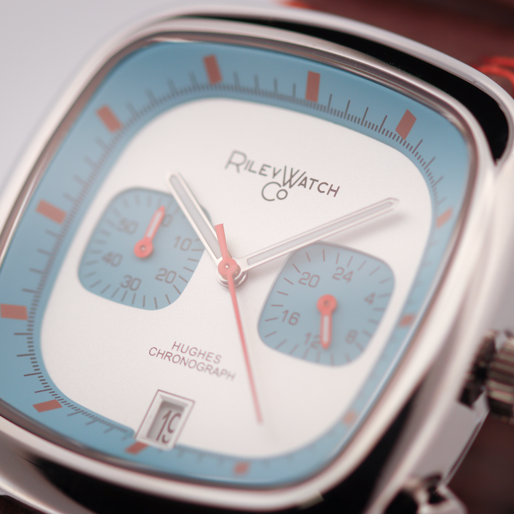 Close-up of a Riley Watch Co. watch with a blue and white face.
