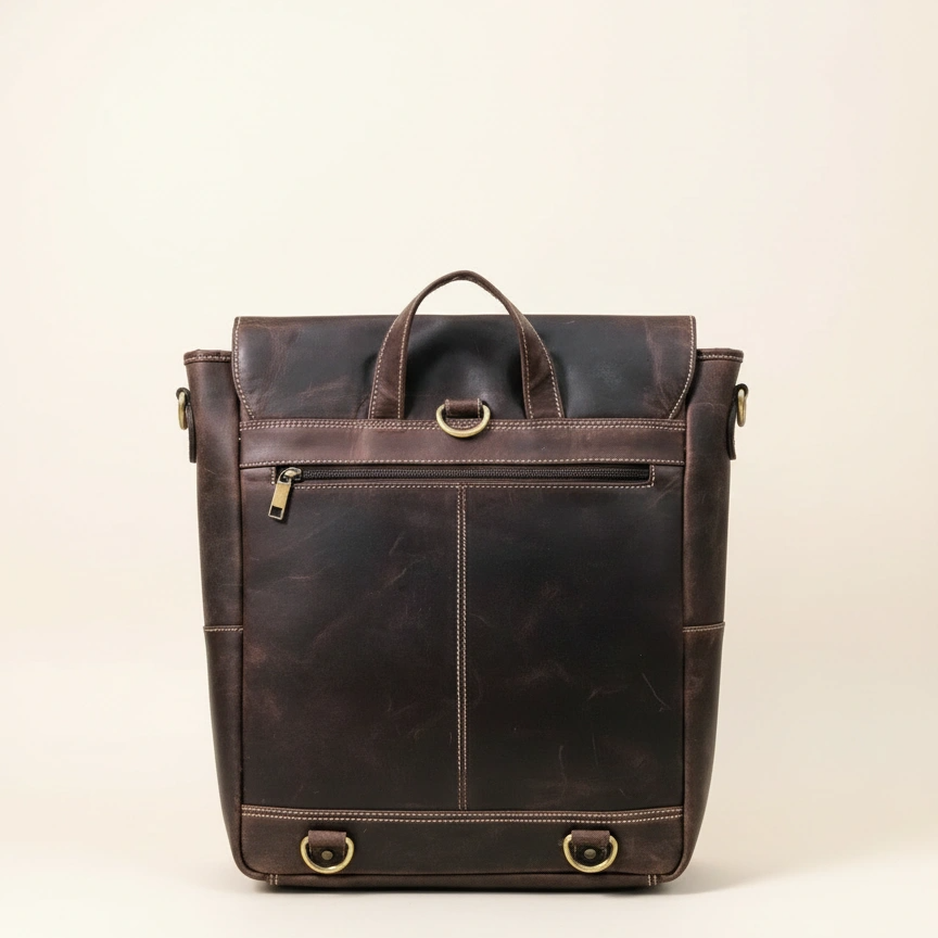 Brown leather backpack on a beige background