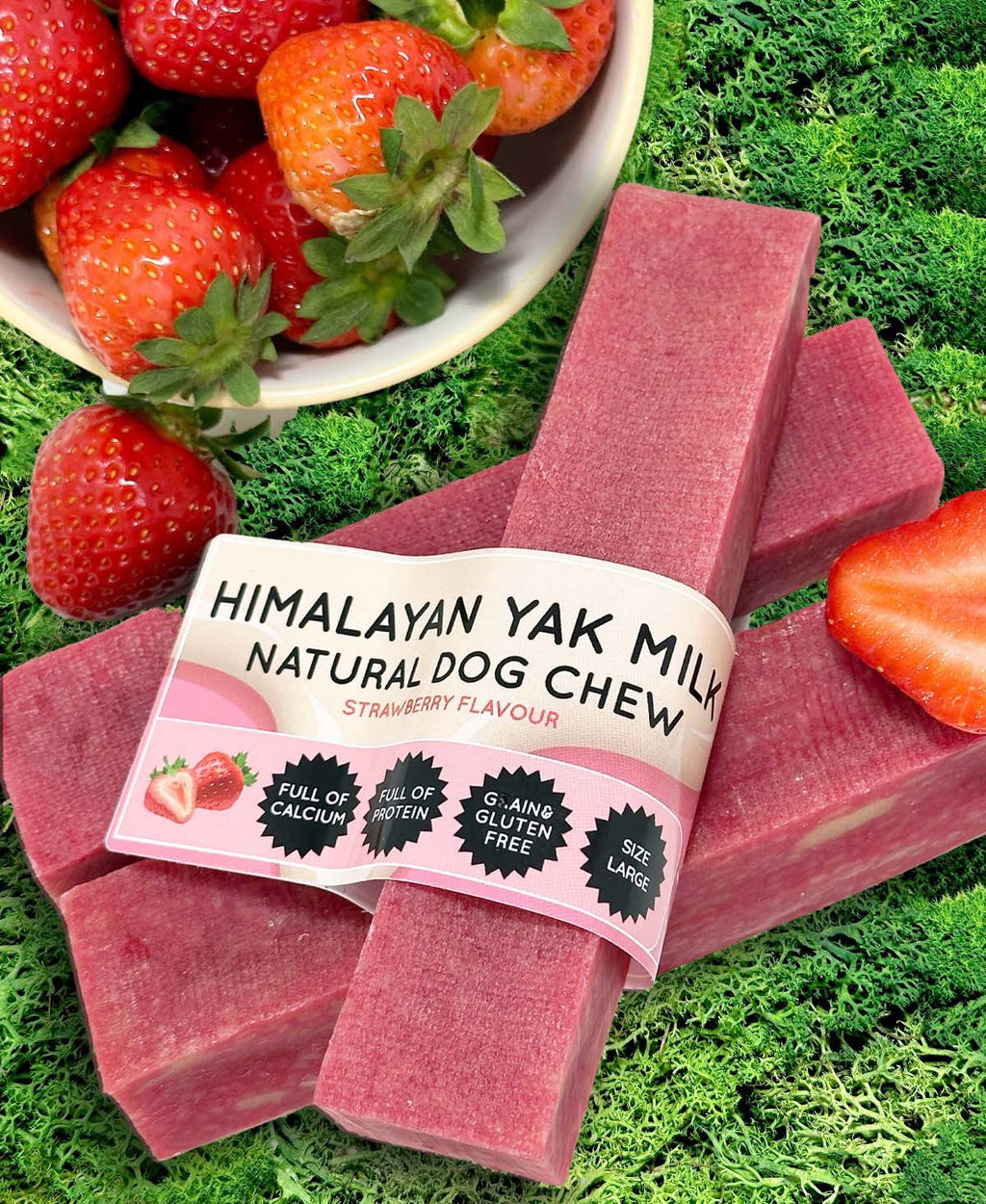 Himalayan Yak Milk Natural Dog Chew with strawberry flavor on a grass background