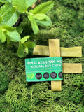 Himalayan Yak Milk Natural Dog Chew packaging on a green moss background
