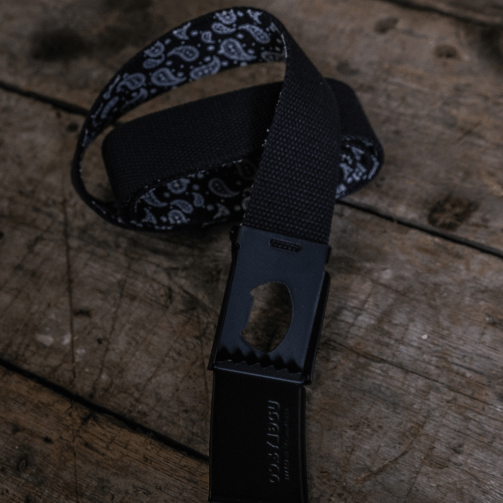 Black lanyard with a metal clip on a wooden surface