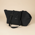 Black bag with a strap on a beige background