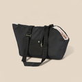 Black bag with a textured surface on a beige background